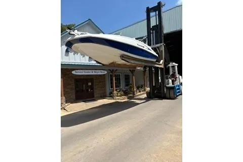 Slide: The Image of 2020 Tahoe 2150 CC boat lifted by forklift outside a storage facility. - 3