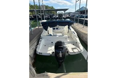 Slide: The Image of 2020 Tahoe 2150 CC boat docked with outboard motor, marina background. - 4