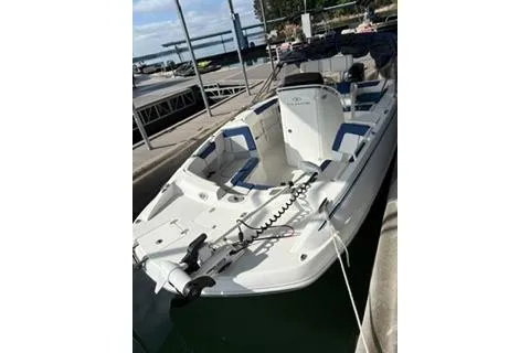Slide: The Image of 2020 Tahoe 2150 CC boat docked at marina, featuring spacious seating and modern design. - 6