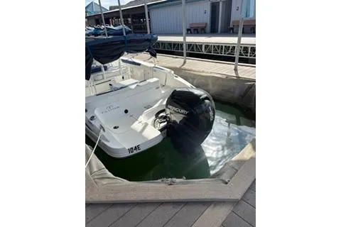 Slide: The Image of 2020 Tahoe 2150 CC boat docked with Mercury outboard engine. - 9