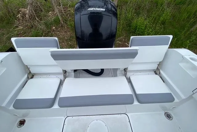 Slide: The Image of 2021 Release 210 RX boat seating with Mercury engine, featuring gray and white cushions. - 13