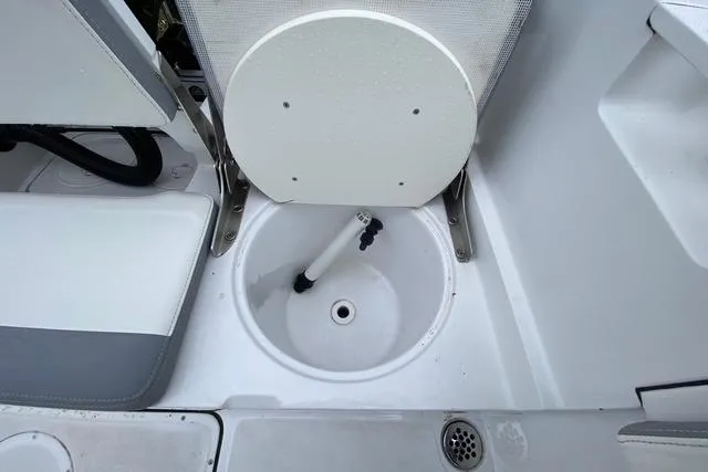 Slide: The Image of 2021 Release 210 RX boat interior with seating and storage compartment. - 14