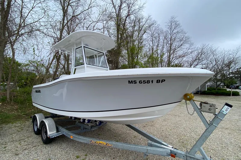 Slide: The Image of 2021 Release 210 RX boat on trailer, parked outdoors. - 2