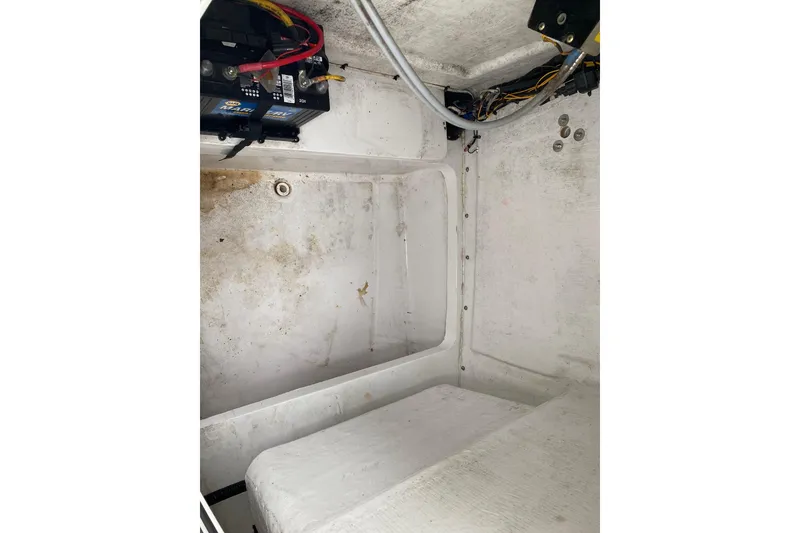 Slide: The Image of Interior view of a 2021 Release 210 RX boat compartment with battery and wiring. - 22