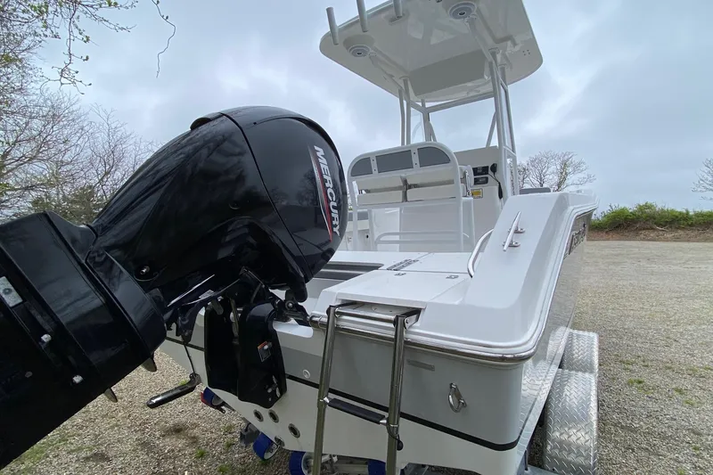Slide: The Image of 2021 Release 210 RX boat with Mercury outboard motor on a trailer. - 3