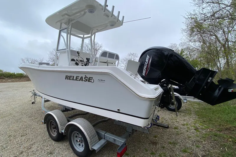 Slide: The Image of 2021 Release 210 RX boat on trailer with Mercury outboard motor. - 4