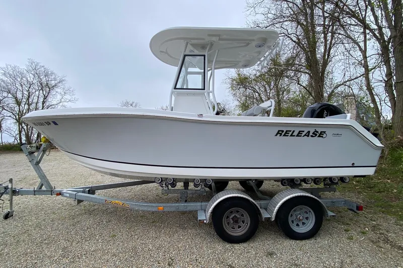 Slide: The Image of 2021 Release 210 RX boat on trailer, side view, outdoors. - 5