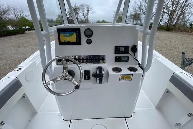 Slide: The Image of Center console of 2021 Release 210 RX boat with steering wheel and navigation display. - 8