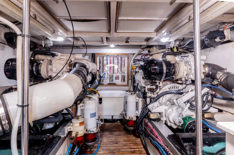 Slide: The Image of Engine room of a 2002 Grand Banks 46 Europa yacht, showcasing dual engines and mechanical systems. - 11
