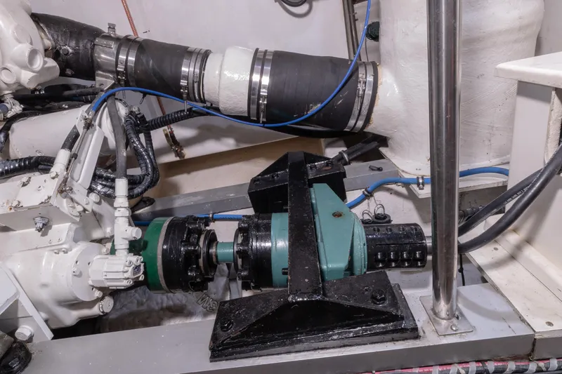 Slide: The Image of Engine room of 2002 Grand Banks 46 Europa, showcasing mechanical components and piping. - 12