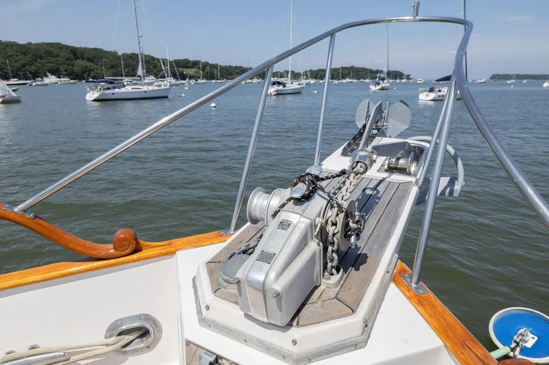 Slide: The Image of Bow view of 2002 Grand Banks 46 Europa yacht with anchor chain, moored in a scenic harbor. - 18