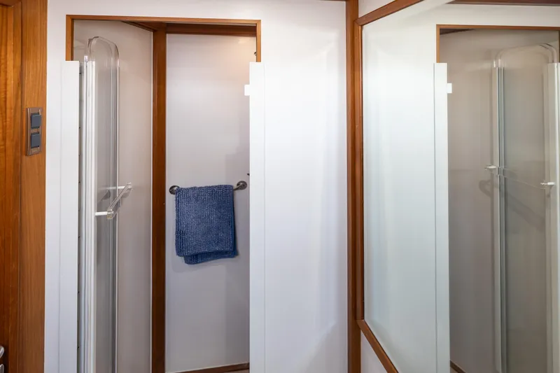 Slide: The Image of Shower area in 2002 Grand Banks 46 Europa yacht with wooden trim and blue towel. - 22