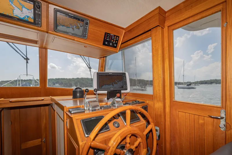 Slide: The Image of Interior helm of 2002 Grand Banks 46 Europa yacht with navigation equipment and scenic view. - 26