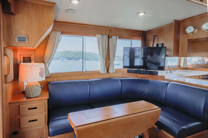 Slide: The Image of Luxurious interior of 2002 Grand Banks 46 Europa yacht with blue seating and TV. - 8