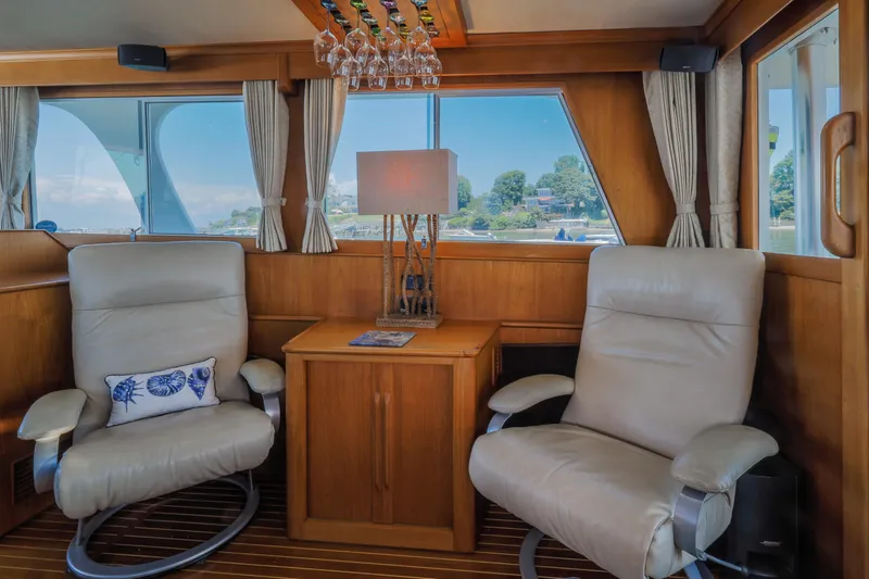 Slide: The Image of Interior of 2002 Grand Banks 46 Europa yacht with leather chairs and wooden decor. - 9