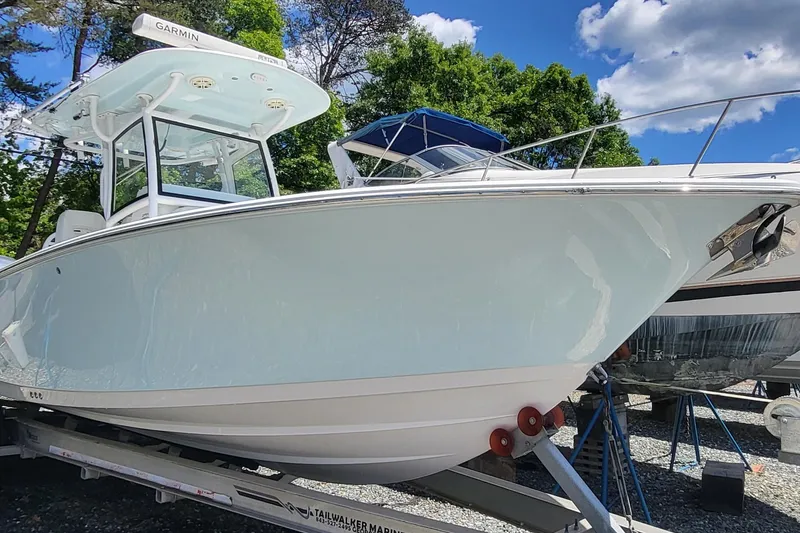 The Image of 2020 Sportsman Open 282 Center Console boat on trailer, under clear blue sky. - 0