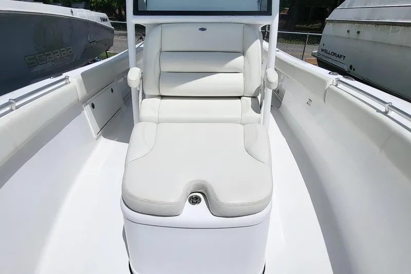 Slide: The Image of 2020 Sportsman Open 282 Center Console boat with white cushioned seating. - 12