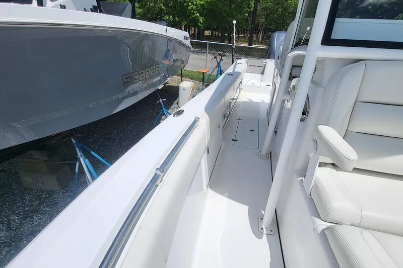 Slide: The Image of 2020 Sportsman Open 282 Center Console boat interior with white seating and sleek design. - 14