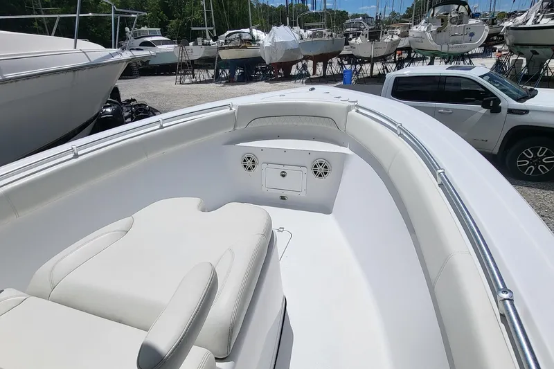 Slide: The Image of 2020 Sportsman Open 282 Center Console boat with spacious seating, parked in a marina. - 15