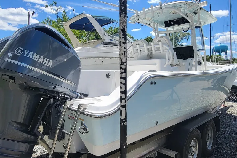 Slide: The Image of 2020 Sportsman Open 282 Center Console boat with Yamaha engine on trailer. - 2