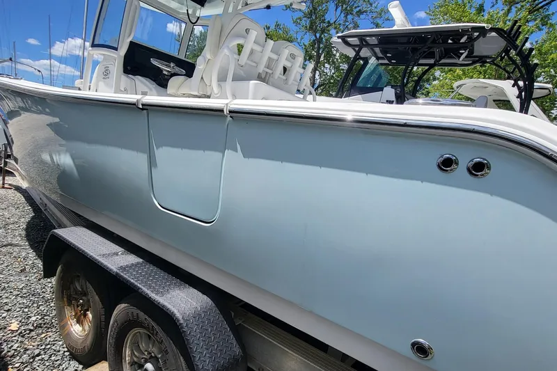 Slide: The Image of 2020 Sportsman Open 282 Center Console boat on trailer, side view. - 3