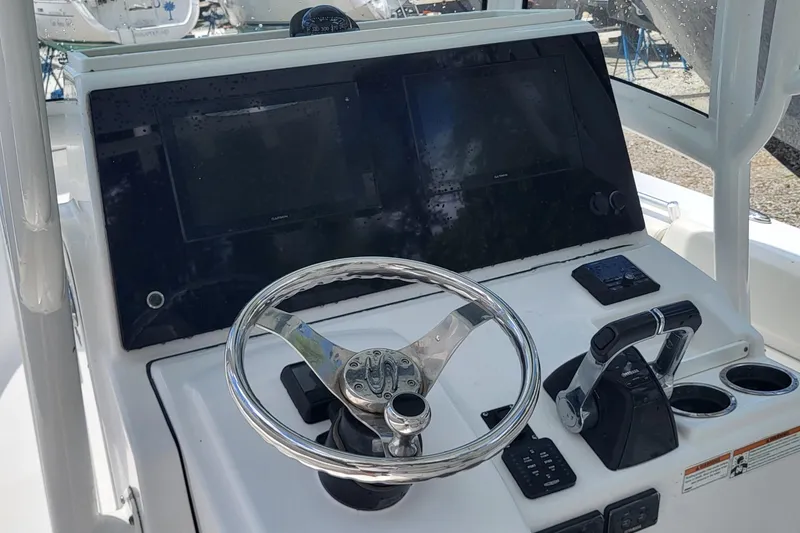Slide: The Image of 2020 Sportsman Open 282 Center Console helm with steering wheel and controls. - 9