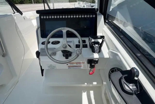 Slide: The Image of Helm of 2026 World Cat 265 DC-X boat with steering wheel and controls. - 4