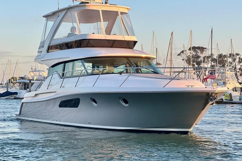 Slide: The Image of 2019 Tiara Yachts F44 Flybridge in marina, showcasing sleek design and luxury features. - 15