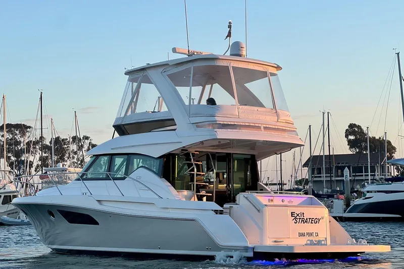 Slide: The Image of 2019 Tiara Yachts F44 Flybridge in marina at sunset, showcasing sleek design and luxury features. - 28