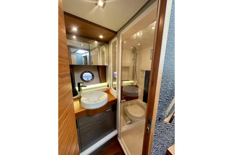 Slide: The Image of 2019 Tiara Yachts F44 Flybridge bathroom with modern fixtures and wood accents. - 40