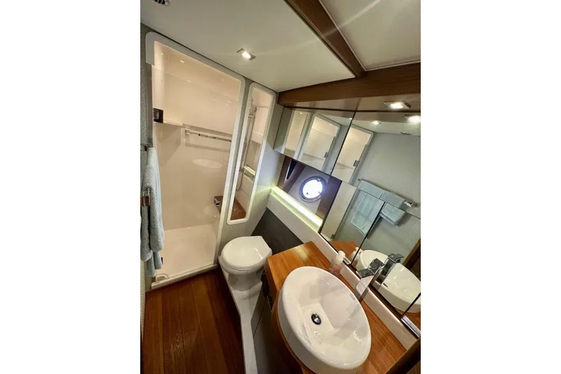 Slide: The Image of Luxurious bathroom in 2019 Tiara Yachts F44 Flybridge with modern fixtures and wood accents. - 42
