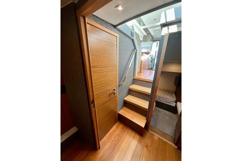 Slide: The Image of 2019 Tiara Yachts F44 Flybridge interior with wooden stairs and modern design. - 44