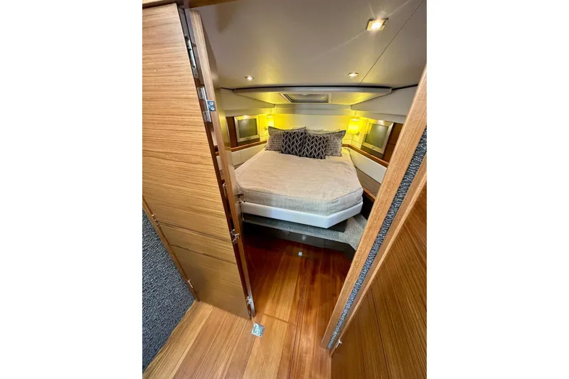 Slide: The Image of Luxurious bedroom interior of 2019 Tiara Yachts F44 Flybridge with elegant wood finishes. - 45