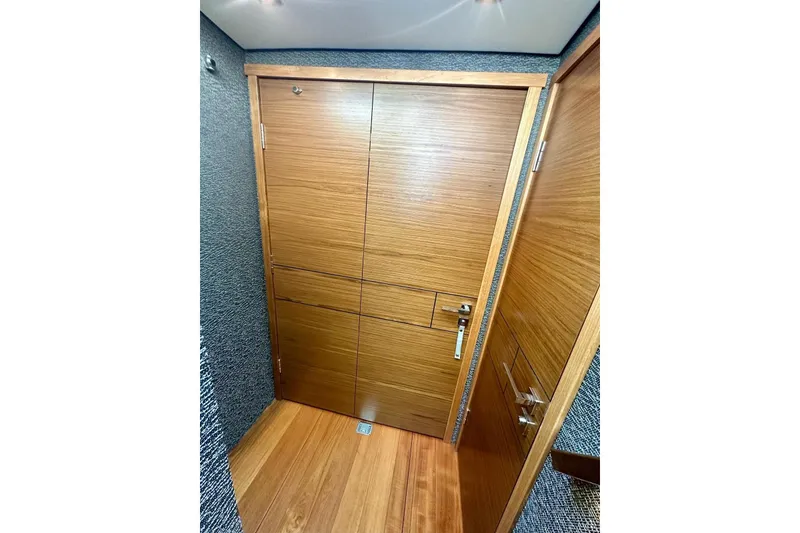 Slide: The Image of Wooden interior door on 2019 Tiara Yachts F44 Flybridge, showcasing sleek design. - 46
