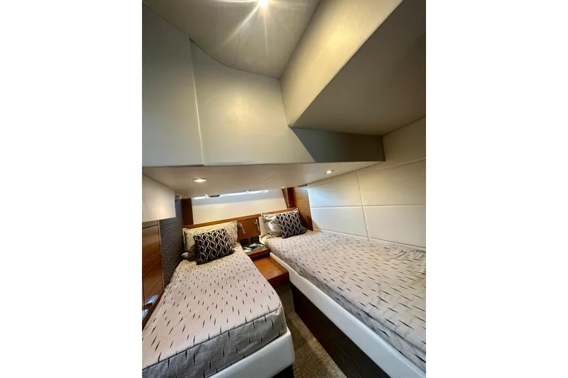 Slide: The Image of 2019 Tiara Yachts F44 Flybridge cabin with twin beds and modern decor. - 48
