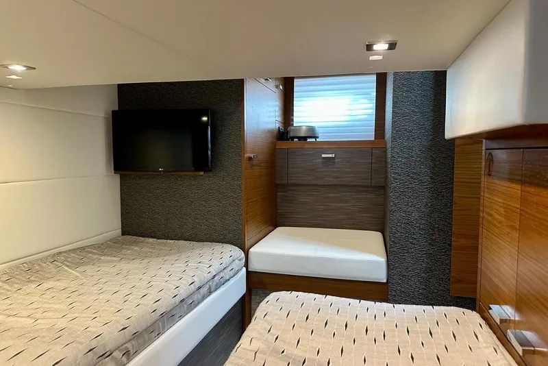 Slide: The Image of Luxurious cabin interior of 2019 Tiara Yachts F44 Flybridge with twin beds and TV. - 50