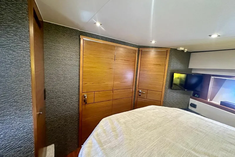 Slide: The Image of Luxurious cabin interior of 2019 Tiara Yachts F44 Flybridge with wood accents and modern amenities. - 52