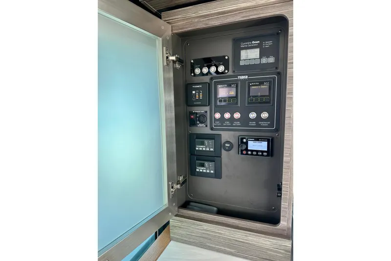 Slide: The Image of Control panel of 2019 Tiara Yachts F44 Flybridge with various switches and displays. - 54