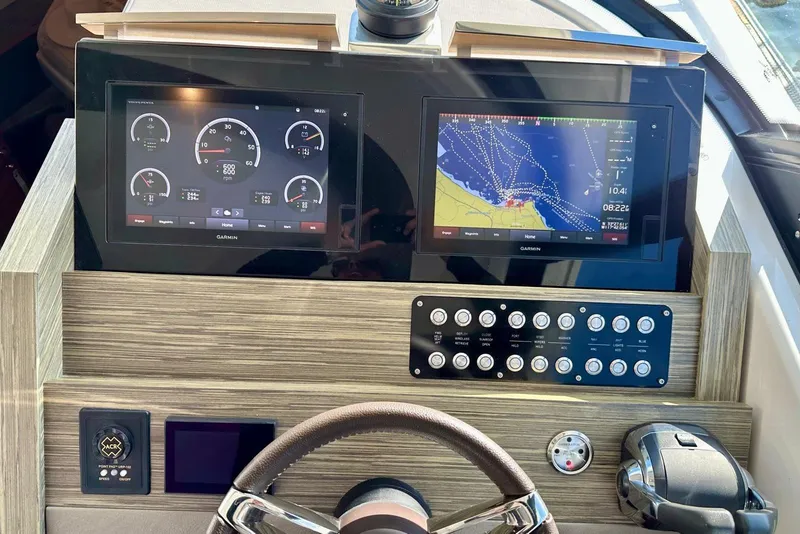 Slide: The Image of Helm of 2019 Tiara Yachts F44 Flybridge with Garmin navigation displays and controls. - 59