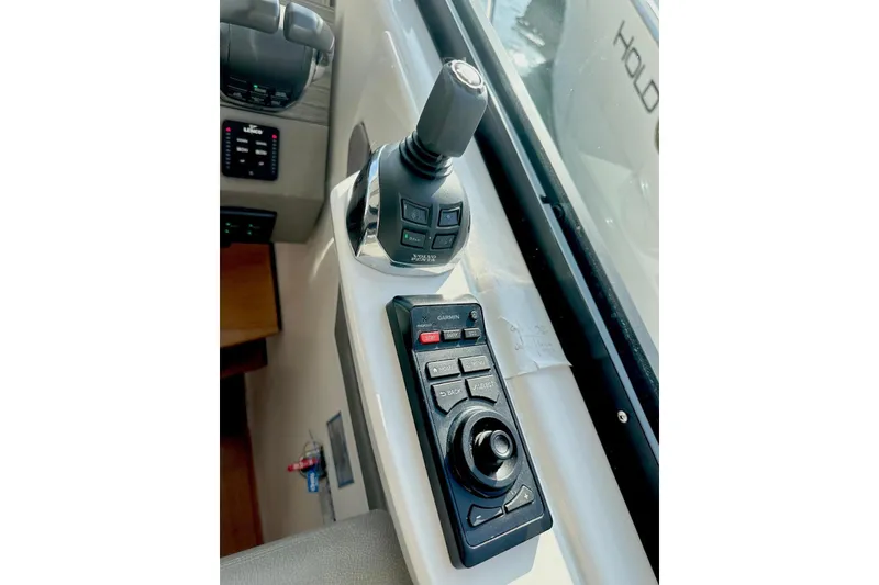 Slide: The Image of Control panel of 2019 Tiara Yachts F44 Flybridge with joystick and Garmin interface. - 62