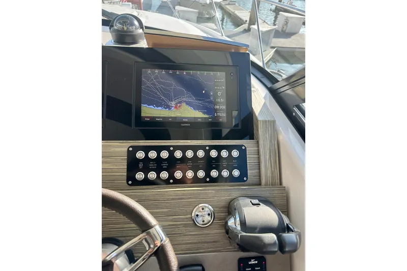 Slide: The Image of Helm of 2019 Tiara Yachts F44 Flybridge with navigation display and controls. - 63