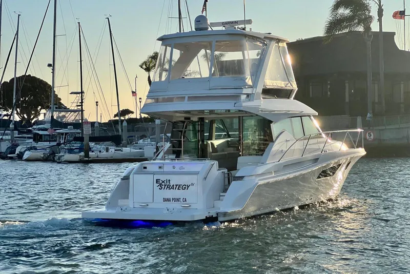 Slide: The Image of 2019 Tiara Yachts F44 Flybridge cruising in marina at sunset, Dana Point, CA. - 67
