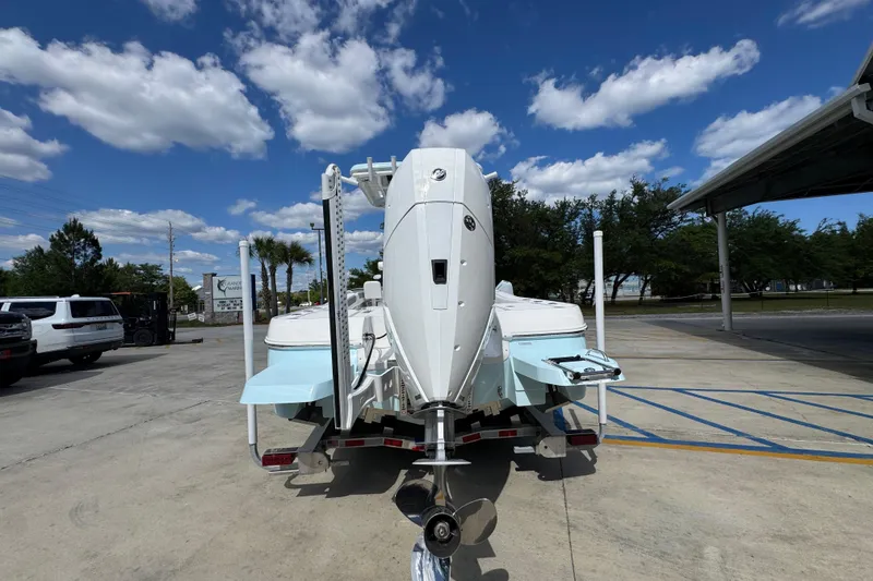 Slide: The Image of 2026 Caymas 26 HB boat on trailer under a clear blue sky. - 13