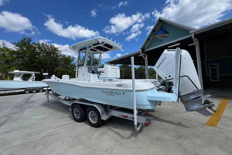 Slide: The Image of 2026 Caymas 26 HB boat on trailer, parked outdoors under a blue sky. - 15