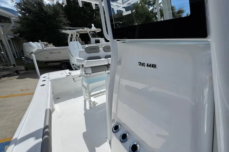 Slide: The Image of 2026 Caymas 26 HB boat interior with seating and console details. - 24