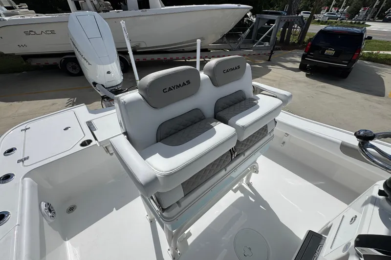 Slide: The Image of 2026 Caymas 26 HB boat interior with dual seats and Mercury engine. - 28