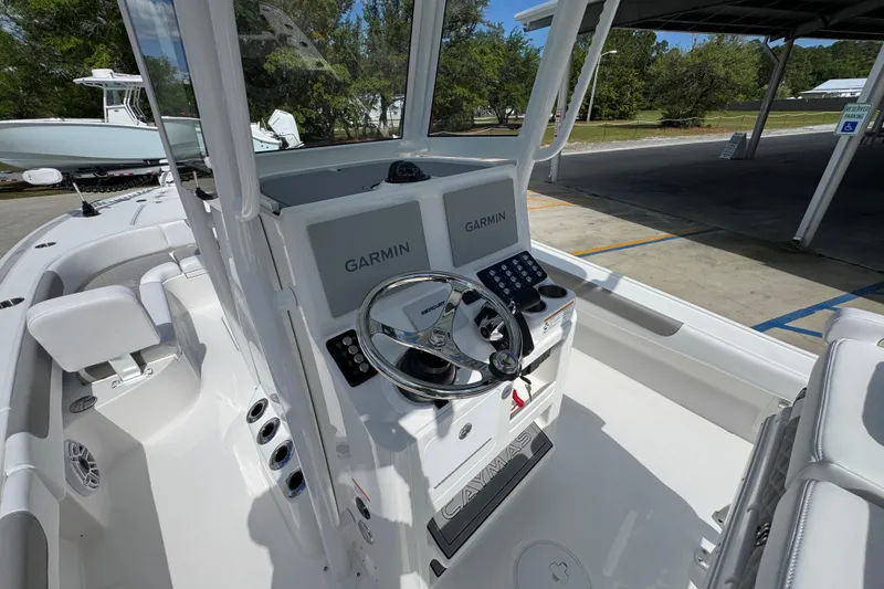 Slide: The Image of 2026 Caymas 26 HB boat cockpit with Garmin navigation system and sleek steering wheel. - 29
