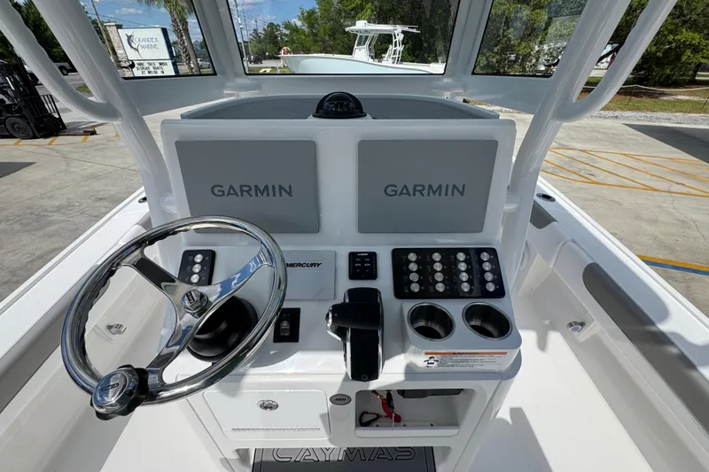 Slide: The Image of 2026 Caymas 26 HB boat helm with Garmin displays and Mercury controls. - 30