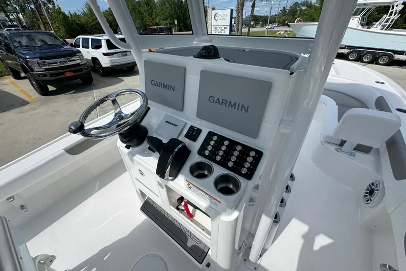 Slide: The Image of 2026 Caymas 26 HB boat console with dual Garmin displays and steering wheel. - 31