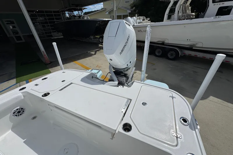 Slide: The Image of 2026 Caymas 26 HB boat with Mercury outboard engine, docked at a marina. - 33